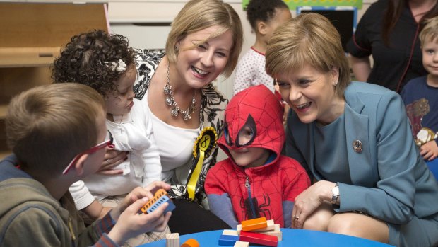 Nicola Sturgeon, leader of the Scottish National Party, right, and Hannah Bardell, a SNP candidate meet children from a nursery in Livingston, Scotland. 