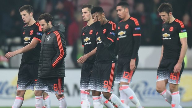 In shock: Manchester United players show their dejection after their defeat.