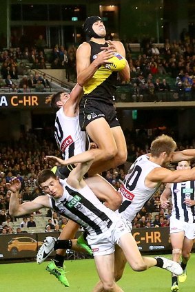 Big grab: Ben Griffiths takes a mark for the Tigers, before later hurting himself attempting another high-flyer.