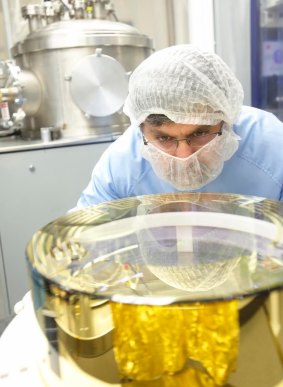 CSIRO technicians work on one of the mirrors that was used in LIGO in the detection of gravitational waves.