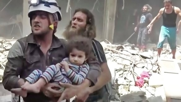 A child is rescued after an airstrike hit in Aleppo.