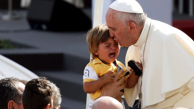 Pope Francis kisses a child as he arrives to lead a mass in Turin, Italy, during a two-day pastoral visit last week. 