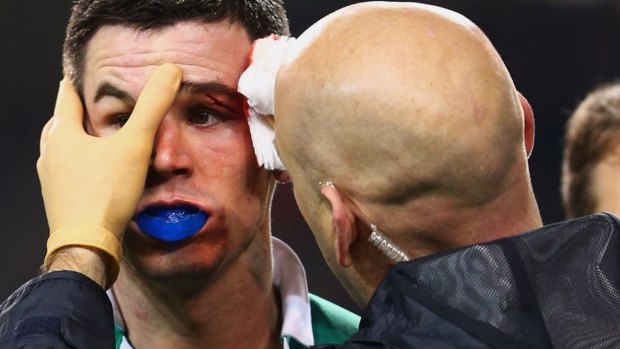 Jonathan Sexton of Ireland is given treatment for a cut to his eye. The Ireland fly-half suffered four concussions last year.