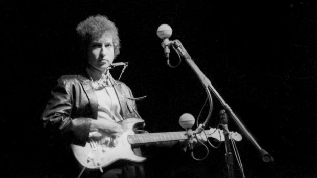 Electrifying ... Dylan controversially plays a Fender Stratocaster for the first time at the Newport Folk Festival, July 25,1965