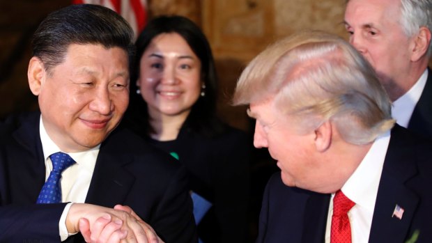 President Donald Trump, right, shakes hands with Chinese President Xi Jinping during a dinner at Mar-a-Lago.