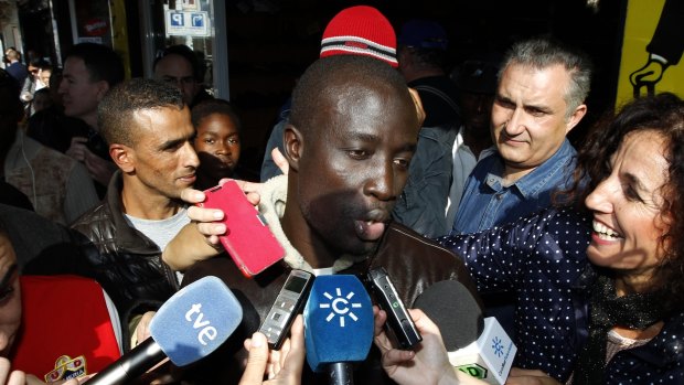 Christmas cheer ... A Senegalese man named Ngame, who told reporters that he was rescued by Spain's coast guard, speaks to the media in Roquetas de Mar after discovering he won euro400,000 ($602,480) in Spain's Christmas lottery.