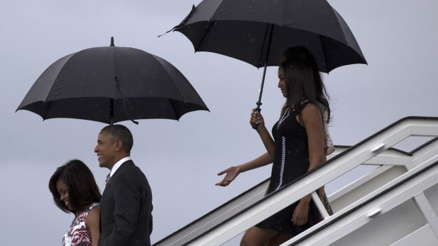 President Barack Obama, arrives with first lady Michelle Obama, left, and their daughters Sasha, front right, and Malia.