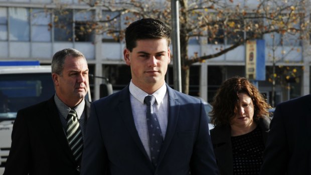 ADFA cadet Jack Toby Mitchell, second from left, arrives at the ACT Supreme Court with his mother and father.