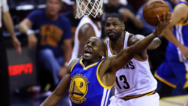Tristan Thompson of the Cavs defends against Andre Iguodala of  Golden State.