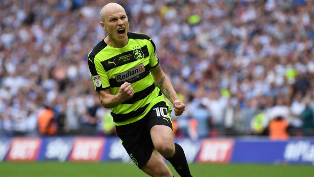 Aaron Mooy celebrates after nailing his penalty in the shootout against Reading.