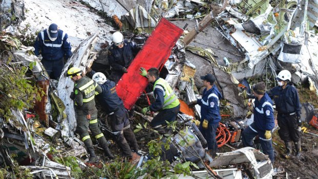 Rescue workers search the wreckage site.