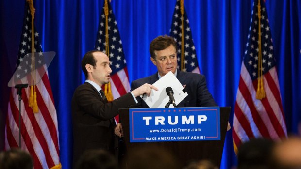 A Trump campaign aide covers the microphone while Paul Manafort checks the teleprompter ahead of a Donald Trump speech in New York in June.