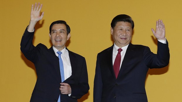 Chinese President Xi Jinping, right, and Taiwanese President Ma Ying-jeou wave to the media at the Shangri-la Hotel in Singapore in November 2015.