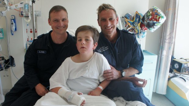 Senior Constable David Crane and Leading Senior Constable Mark Braun from the Police Search and Rescue that found Luke, visit him in hospital. 