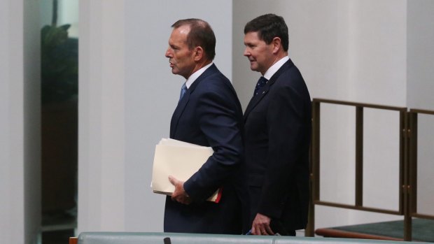 Backbenchers Tony Abbott and Kevin Andrews take their seats for question time in October.