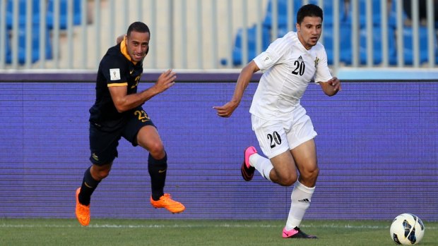 Giving chase: Tarek Elrich pursues Hamza Aldaradreh during the Socceroos' 2-0 loss to Jordan. 