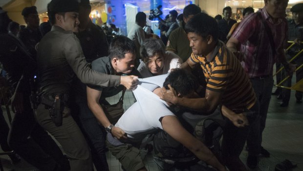 Thai police arrest a student during an anti junta demonstration on May 22, 2015 in Bangkok.