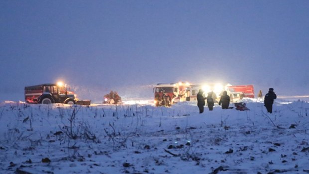 In this photo provided by the Russian Emergency Situations Ministry, emergency crews work at the scene of a AN-148 plane crash.