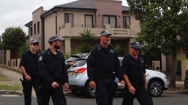 Police search for evidence in Merrylands following the shooting.