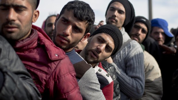 Migrants wait in line to have errors in their transit documents corrected by Greek authorities at a camp in Idomeni, on the Greek-Macedonian border.