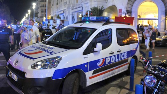 A police car is parked near the scene of the attack.