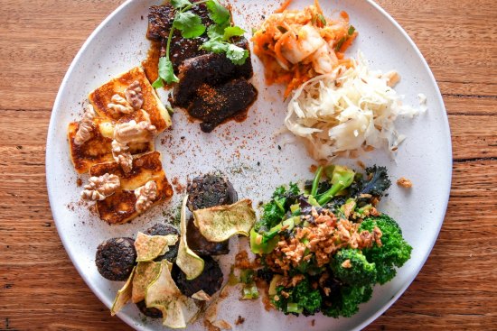 Build your own tasting plate, perhaps (pictured clockwise from top left) Korean-style beef short rib, pickles, miso greens, house-made black pudding with apple, and haloumi with walnuts and honey.