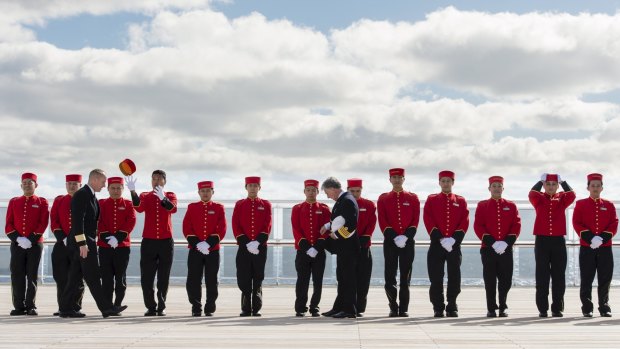Fanfare: Bellboys line up for inspection on the Queen Mary 2.  