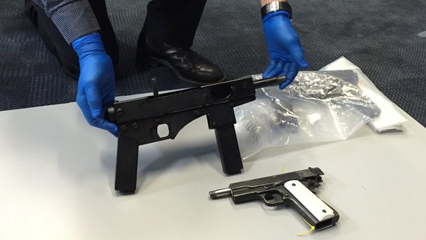 Police found "uzi-style" submachine guns and handguns on the Gold Coast on Friday.