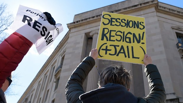 Protesters gather outside the Justice Department in Washington