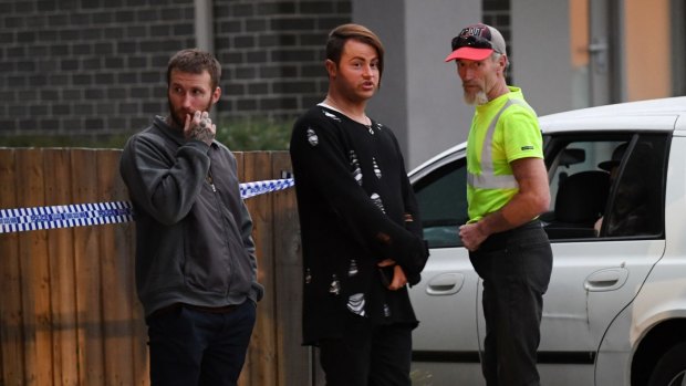 Two of Leonie Stuart's sons and her husband outside their home after the shooting in March.