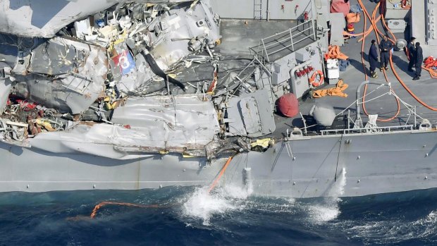 The damage on the starboard side of the USS Fitzgerald is seen off the Japanese coast.