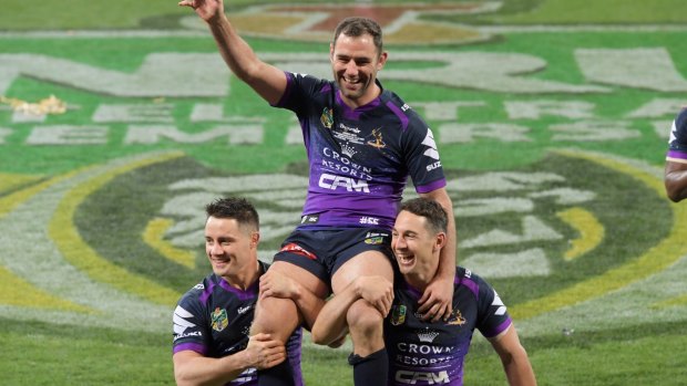 Immortals-in-waiting: Cameron Smith is chaired off by Billy Slater and Cooper Cronk.