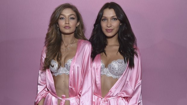 Sisters Gigi and Bella Hadid pose backstage prior to the 2016 Victoria's Secret Fashion Show in Paris.