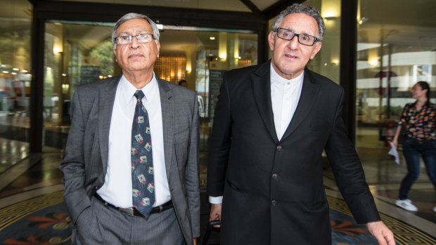 Samir Ishak (left) leaves the Downing Centre District Court with his barrister, Gregory Stanton.