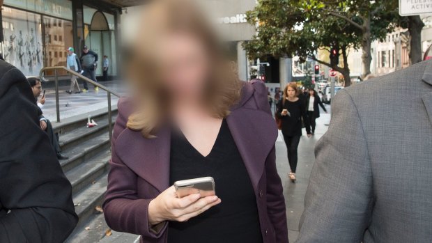 The woman, who cannot be identified, leaves the Downing Centre court complex.
