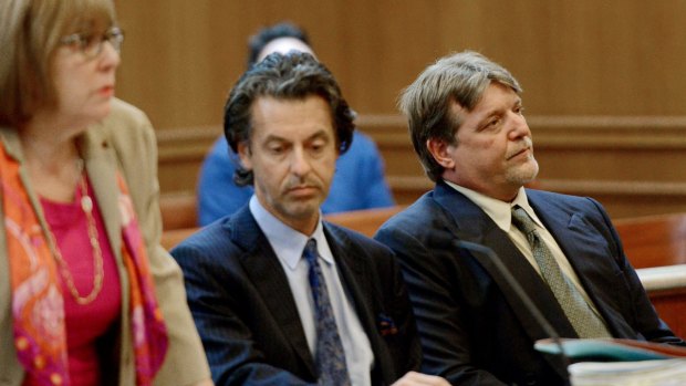 Dennis Nebus, right, sits in court with his lawyers.