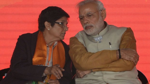 Indian Prime Minister Narendra Modi talks with the Bharatiya Janata Party candidate for Delhi chief minister, Kiran Bedi, during an election rally in New Delhi. 