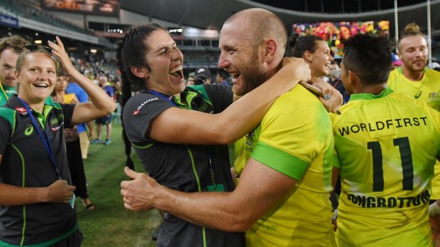 Charlotte Caslick congratulates Australian men's sevens veteran Chucky Stannard on their 2018 Sydney Sevens win.