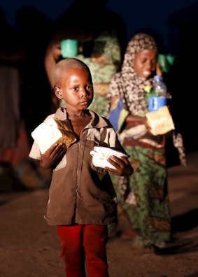 One of the rescued children with a piece of bread at a refugee camp in Yola.