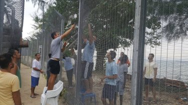 Manus Island refugees are securing damaged perimeter fences at the processing centre against possible attacks.