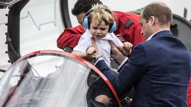 Prince George checks out the cockpit of a red arrow plane at the Royal International Air Tattoo at RAF Fairford in Gloucestershire, England.