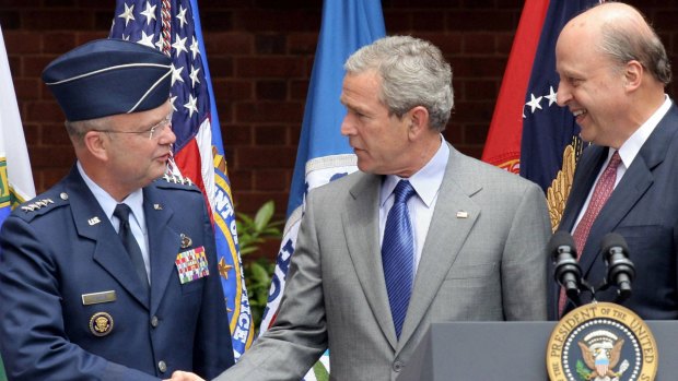 US president George W. Bush shakes hands with Air Force General Michael Hayden, director of the CIA at the time of the Mughniyah assassination, in 2005. John Negroponte, then Director of National Intelligence, looks on.