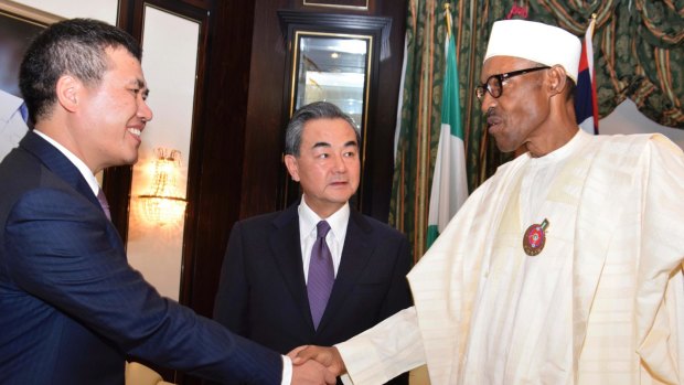 Chinese Ambassador to Nigeria, Zhou Pingjian, left, Chinese Foreign Minister, Wang Yi, centre, are welcome by Nigeria President Muhammadu Buhari, right.