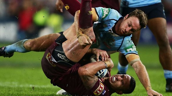 Solid performance: James Maloney tackles Darius Boyd in the Blues' loss to the Maroons on Monday night.