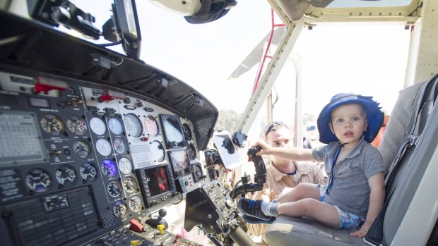 Cooper Pitts, 2, checks out the helicopter controls at the Rural Fire Service open day.