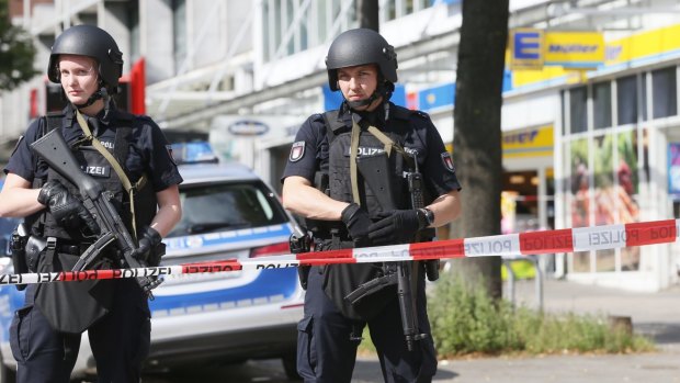 Police officers secure the area after a knife attack at a supermarket in Hamburg on Friday.
