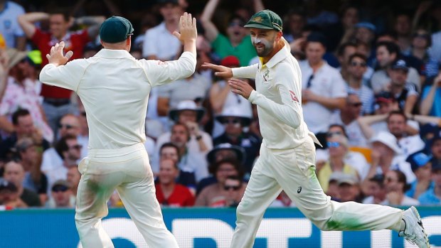 The turning point: Nathan Lyon (right) celebrates with David Warner after running out James Vince at the Gabba in the first Test.