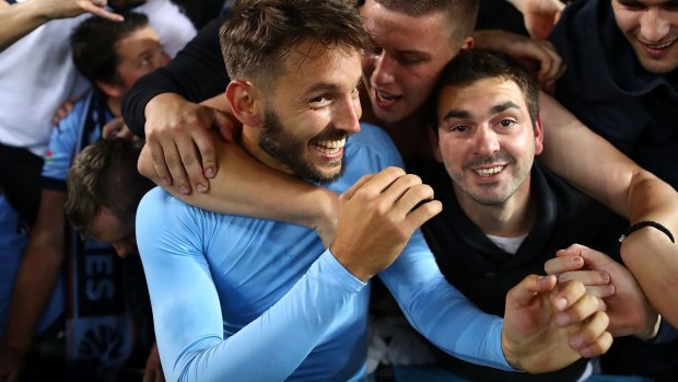 Happy days: Milos Ninkovic of Sydney FC celebrates with fans after the derby win against the Wanderers.
