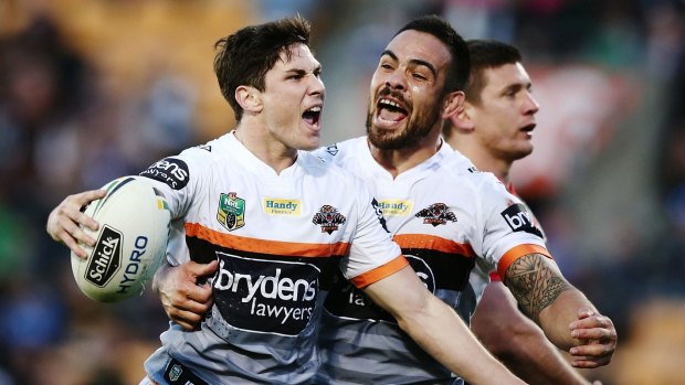 Happy days are here again: Mitchell Moses celebrates his vital try against the Warriors with Dene Halatau.