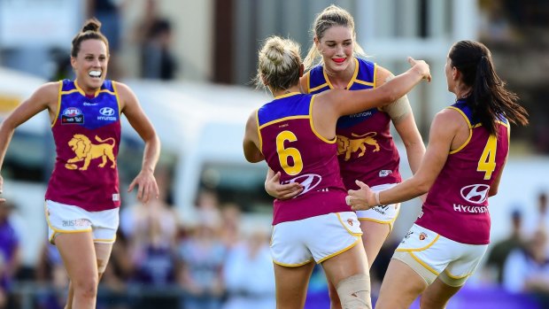 Tayla Harris leads Lions celebrations during an AFLW win.